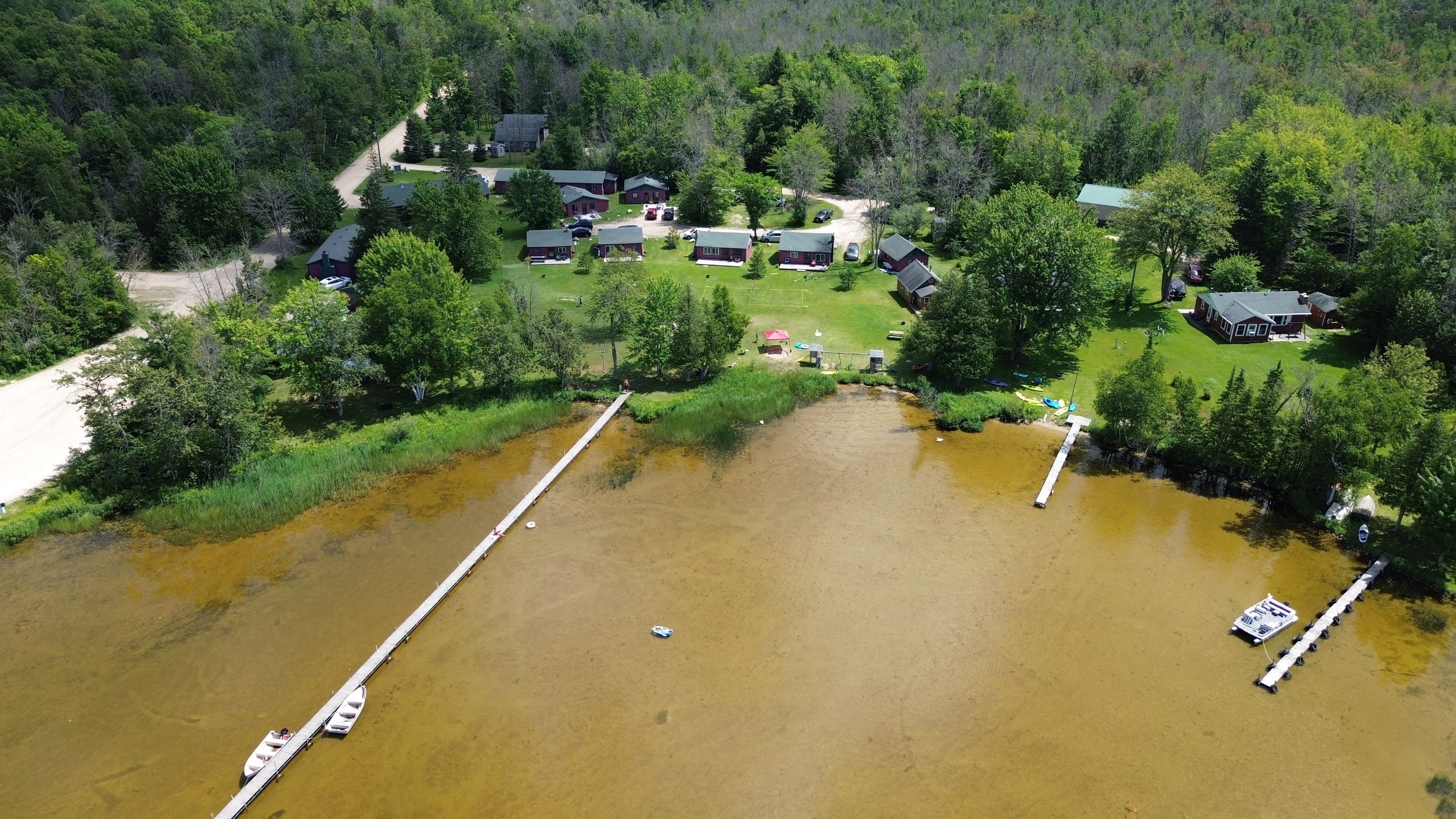Aerial view of Sunset Pines Resort cabins along South Manistique Lake