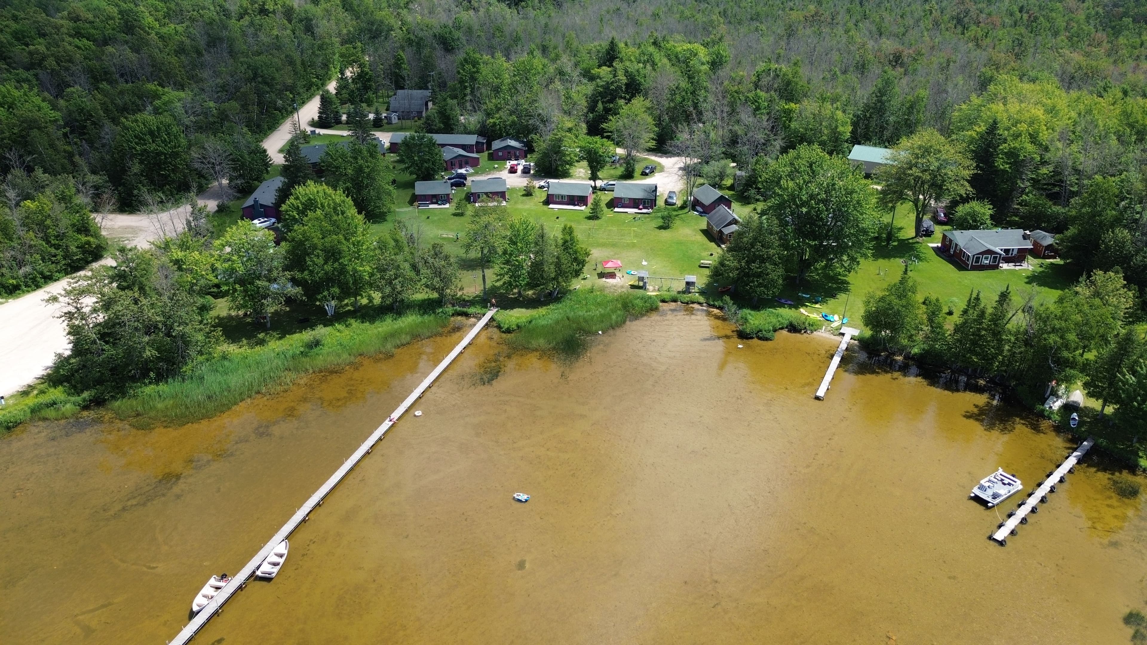 Aerial view of Sunset Pines Resort cabins along South Manistique Lake